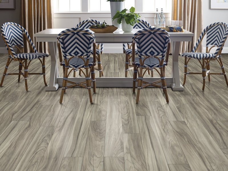 Dining room with wood-look laminate flooring from Carneys Carpet Gallery in Jeffersontown, KY